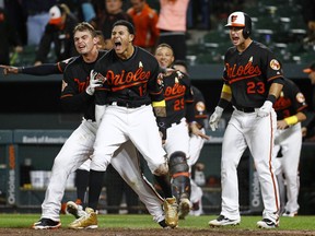 Baltimore Orioles' Manny Machado (13) celebrates with teammates after scoring on Jonathan Schoop's double in the 13th inning of a baseball game against the Toronto Blue Jays in Baltimore, Friday, Sept. 1, 2017. Baltimore won 1-0. (AP Photo/Patrick Semansky)