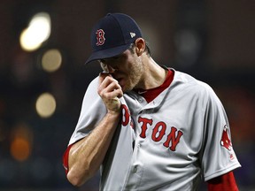 Boston Red Sox starting pitcher Doug Fister wipes his face as he walks off the field at the end of the second inning of a baseball game against the Baltimore Orioles in Baltimore, Monday, Sept. 18, 2017. Baltimore scored three runs against Fister in the second. (AP Photo/Patrick Semansky)