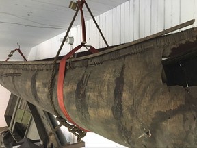In a  2017 photo, a Wabanaki-made birch canoe that was carbon-dated to the 1700s is seen hanging in a barn behind the Pejepscot Historical Society museum in Brunswick, Maine. The canoe, possibly the oldest such canoe in existence, has been removed for conservation and will go on display inside the museum as early as this fall. (Pejepscot Historical Society/Larissa Vigue Picard via AP)
