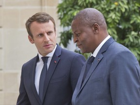 French President Emmanuel Macron, left, welcomes Central African Republic President Faustin Archange Touadera at the Elysee Palace in Paris, France, Monday, Sept. 25, 2017. (AP Photo/Michel Euler)