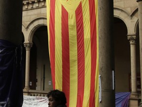 An ''estelada'' or Catalonia independence flag is displayed during a protest inside the public university in Barcelona, Spain, Tuesday, Sept. 26, 2017. Spain's government on Tuesday ordered Catalonia's regional police force to identify officials at local schools and other civic buildings expected to be used as polling stations in a controversial independence referendum. (AP Photo/Manu Fernandez)