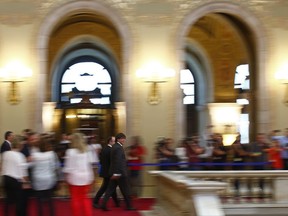 Catalonia regional President Carles Puigdemont, center, walks toward a plenary session at the Parliament of Catalonia in Barcelona, Spain, Wednesday, Sept. 6, 2017. Catalan lawmakers are voting on a bill that will allow regional authorities to officially call an Oct. 1 referendum on a split from Spain, making concrete a years-long defiance of central authorities, who see the vote as illegal. (AP Photo/Manu Fernandez)