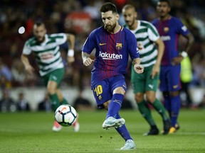 FC Barcelona's Lionel Messi scores a penalty during the Spanish La Liga soccer match between FC Barcelona and Eibar at the Camp Nou stadium in Barcelona, Spain, Tuesday, Sept. 19, 2017. (AP Photo/Manu Fernandez)