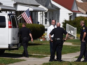 Police investigate at a home where two children were shot in Dearborn, Mich., Wednesday, Sept. 27, 2017. Police said the young children were wounded in the apparently accidental shooting at the home that was being used for childcare in suburban Detroit. (Tanya Moutzalias  /The Ann Arbor News via AP)