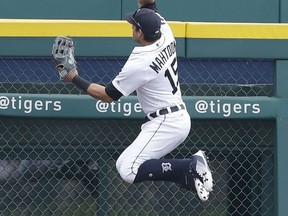 Detroit Tigers left fielder Mikie Mahtook leaps but is unable to catch the solo home run hit by Cleveland Indians' Jose Ramirez during the first inning of a baseball game, Sunday, Sept. 3, 2017, in Detroit. (AP Photo/Carlos Osorio)