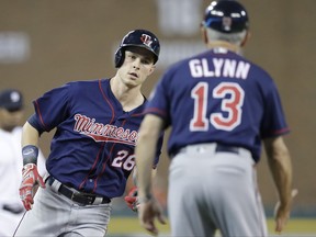 Minnesota Twins' Max Kepler is greeted by third base coach Gene Glynn after a solo home run during the third inning of a baseball game against the Minnesota Twins, Friday, Sept. 22, 2017, in Detroit. (AP Photo/Carlos Osorio)
