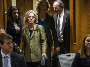 Corinne Miller, former director of the Michigan Bureau of Disease Control Prevention and Epidemiology, enters the courtroom before serving as a witness during the preliminary examination of Nick Lyon, Michigan Department of Health and Human Services director, on Friday, Sept. 22, 2017, in Genesee County District Court in Flint, Mich. Lyon faces charges of involuntary manslaughter and misconduct in office for his response to the Flint Water Crisis. His court preceedings have progressed farther than those of other public officials facing criminal charges in connection to the crisis. Lyon's exam was conducted in front of Judge David J. Goggins. (Terray Sylvester /The Flint Journal-MLive.com via AP)