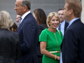 U.S. Education Secretary Betsy DeVos arrives at the dedication ceremony of Michigan State University's new Grand Rapids Medical Research Center on Wednesday, Sept. 20, 2017, in Grand Rapids, Mich.  (Cory Morse /The Grand Rapids Press via AP)