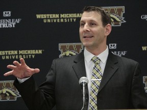 FILE - In this Jan. 14, 2017, file photo, Tim Lester speaks as he made his first public appearance as the new NCAA college football head coach at Western Michigan University, in Kalamazoo, Mich. Tim Lester is among the thousands of football men who became big fans of Sam Darnold last season. Just 11 days after Darnold's 453-yard, five-touchdown performance for Southern California in the last Rose Bowl, Lester got the head coaching job at Western Michigan _ and Darnold became his first problem. (Jake Green/Kalamazoo Gazette-MLive Media Group via AP, File)