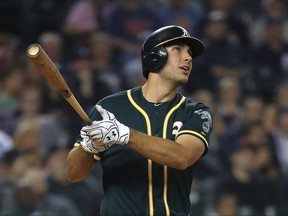 Oakland Athletics' Matt Olson watches his solo home run against the Detroit Tigers in the second inning of a baseball game in Detroit, Tuesday, Sept. 19, 2017. (AP Photo/Paul Sancya)