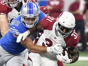 Detroit Lions defensive tackle Anthony Zettel (69) stops Arizona Cardinals running back David Johnson (31) during an NFL football game in Detroit, Sunday, Sept. 10, 2017. (AP Photo/Jose Juarez)