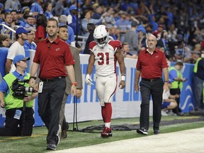 Arizona Cardinals running back David Johnson (31) walks off the field with medical staff for X-rays during an NFL football game against the Detroit Lions in Detroit, Sunday, Sept. 10, 2017. (AP Photo/Jose Juarez)