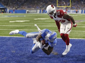 Detroit Lions wide receiver Kenny Golladay (19) catches a 10-yard touchdown pass as Arizona Cardinals cornerback Justin Bethel (28) defends during the second half of an NFL football game in Detroit, Sunday, Sept. 10, 2017. (AP Photo/Duane Burleson)