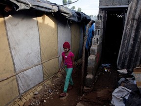A Rohingya Muslim girl walks in front of their shanty at a camp for refugees in Hyderabad, India, Monday, Sept. 18, 2017. India's government said Monday that it has evidence there are extremists who pose a threat to the country's security among the Rohingya Muslims who have fled Myanmar and settled in many Indian cities. India's Supreme Court was hearing a petition filed on behalf of two Rohingya refugees challenging a government decision to deport the ethnic group from India. (AP Photo/Mahesh Kumar A.)