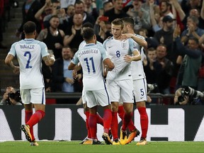 England's Eric Dier is celebrated by teammates after scoring during the World Cup Group F qualifying soccer match between England and Slovakia at Wembley Stadium in London, England, Monday, Sept. 4, 2017. (AP Photo/Kirsty Wigglesworth)
