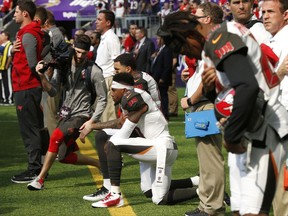 Tampa Bay Buccaneers wide receiver DeSean Jackson, center, takes a knee during the national anthem before an NFL football game against the Minnesota Vikings, Sunday, Sept. 24, 2017, in Minneapolis. (AP Photo/Jim Mone)