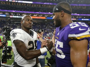 New Orleans Saints running back Adrian Peterson, left, talks with Minnesota Vikings outside linebacker Anthony Barr, right, after an NFL football game, Monday, Sept. 11, 2017, in Minneapolis. The Vikings won 29-19. (AP Photo/Bruce Kluckhohn)