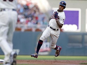 Minnesota Twins' Byron Buxton heads for third on an RBI triple off Kansas City Royals pitcher Onelki Garcia in the first inning of a baseball game Saturday, Sept, 2, 2017, in Minneapolis. (AP Photo/Jim Mone)