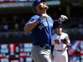Toronto Blue Jays' Josh Donaldson, foreground, celebrates his solo home run off Minnesota Twins pitcher Kyle Gibson, background right, in the first inning of a baseball game Sunday, Sept. 17, 2017, in Minneapolis. (AP Photo/Jim Mone)