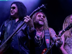 Gene Simmons, left, performs at The Children Matter: Houston Benefit Concert at CHS Field Wednesday, Sept. 20, 2017 in  in St. Paul, Minn. Original Kiss members Gene Simmons and Ace Frehley reunited for their first public appearance since their group was inducted into the Rock and Roll Hall of Fame in 2014. (Carlos Gonzalez/Star Tribune via AP)