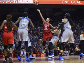 Washington Mystics guard Kristi Toliver (20) shoots and is fouled by Minnesota Lynx guard Seimone Augustus (33) during the second quarter of a WNBA basketball playoff game Thursday, Sept. 14, 2017, in Minneapolis. (Aaron Lavinsky/Star Tribune via AP)