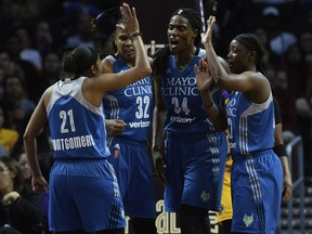 Minnesota Lynx players celebrate a blocked shot by center Sylvia Fowles (34) against Los Angeles Sparks guard Odyssey Sims in the first half in Game 3 of a WNBA basketball finals game, Friday, Sept. 29, 2017, in Los Angeles. (Aaron Lavinsky/Star Tribune via AP)