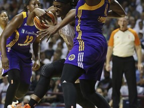 Minnesota Lynx center Sylvia Fowles (34) tries to push the ball through the defense of Los Angeles Sparks center Jantel Lavender (42) in the first half of Game 1 in the WNBA basketball finals game, Sunday, Sept. 24, 2017, in Minneapolis. (AP Photo/Stacy Bengs)