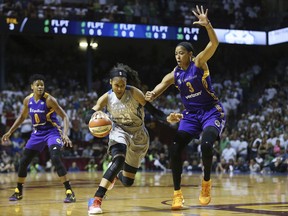 Minnesota Lynx forward Maya Moore (23) drives the ball around Los Angeles Sparks center Candace Parker (3) in the first half of Game 1 in the WNBA basketball final, Sunday, Sept. 24, 2017, in Minneapolis. (AP Photo/Stacy Bengs)