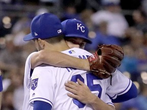 Kansas City Royals starting pitcher Danny Duffy hugs Eric Hosmer (35) as he comes out of a baseball game during the fifth inning  against the Detroit Tigers Thursday, Sept. 28, 2017, in Kansas City, Mo. (AP Photo/Charlie Riedel)