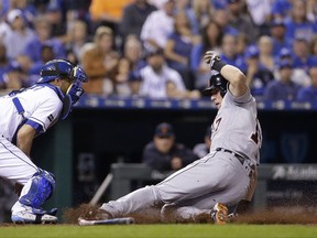 Detroit Tigers' Andrew Romine, right, beats the tag by Kansas City Royals catcher Drew Butera to score on a single by JaCoby Jones during the fifth inning of a baseball game Thursday, Sept. 28, 2017, in Kansas City, Mo. (AP Photo/Charlie Riedel)