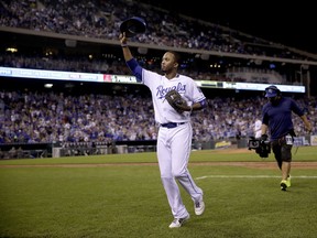 Kansas City Royals' Alcides Escobar acknowledges the crowd as he comes out of a baseball game during the seventh inning gainst the Arizona Diamondbacks, Saturday, Sept. 30, 2017, in Kansas City, Mo. (AP Photo/Charlie Riedel)