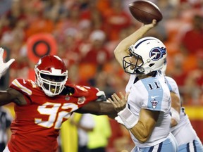 Tennessee Titans quarterback Alex Tanney (11) throws under pressure from Kansas City Chiefs defensive lineman Tanoh Kpassagnon (92) during the first half of an NFL preseason football game in Kansas City, Mo., Thursday, Aug. 31, 2017. (AP Photo/Colin E. Braley)