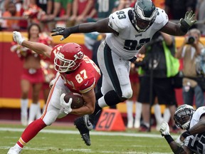 Philadelphia Eagles defensive tackle Tim Jernigan (93) goes airborne while tackling Kansas City Chiefs tight end Travis Kelce (87) during the second half of an NFL football game in Kansas City, Mo., Sunday, Sept. 17, 2017. (AP Photo/Ed Zurga)