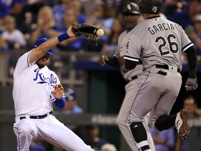 Kansas City Royals first baseman Eric Hosmer, left, loses the ball as Chicago White Sox Avisail Garcia (26) reaches first base with an RBI single during the fourth inning of a baseball game at Kauffman Stadium in Kansas City, Mo., Monday, Sept. 11, 2017. (AP Photo/Orlin Wagner)