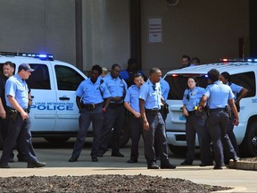 St. Louis Police gather at Barnes-Jewish Hospital after two officers were shot in North St. Louis, on Friday, Sept. 1, 2017. (Christian Gooden/St. Louis Post-Dispatch via AP)