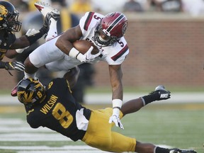 South Carolina running back Rico Dowdle, top, is tackled by Missouri's Thomas Wilson during the first quarter of an NCAA college football game, Saturday, Sept. 9, 2017, in Columbia, Mo. (Chris Lee/St. Louis Post-Dispatch via AP)