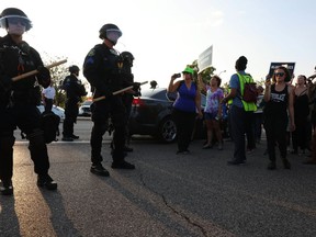 St. Louis County police say they broke up a demonstration near an upscale mall because protesters weren't listening to instructions and tried to evade two lines of officers blocking the on-ramp to a highway, Wednesday, Sept. 20, 2017, in St. Louis. Protests have taken place since Friday's acquittal of a white former St. Louis police officer for the fatal shooting of black drug suspect. (Christian Gooden/St. Louis Post-Dispatch via AP)
