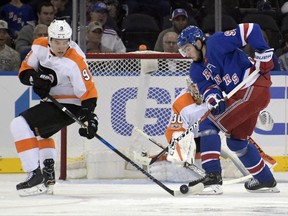 Philadelphia Flyers defenseman Ivan Provorov, left, and New York Rangers center Mika Zibanejad vie for control of the puck during the first period of an NHL hockey preseason game Monday, Sept. 25, 2017, at Madison Square Garden in New York. (AP Photo/Bill Kostroun)