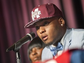 FILE - In this Feb. 5, 2015, file photo, Brookhaven High School football player Leo Lewis announces his decision to attend Mississippi State during a signing day event at the school in Brookhaven, Miss. Mississippi State players Lewis and Kobe Jones have, according to court documents, told the NCAA they received free merchandise from a clothing store while on recruiting trips to Ole Miss, something that would violate NCAA rules. They did so after being granted limited immunity by the NCAA, which protects them from being declared ineligible for wrongdoing as long as they told the truth. (Joe Ellis/The Clarion-Ledger via AP, File)