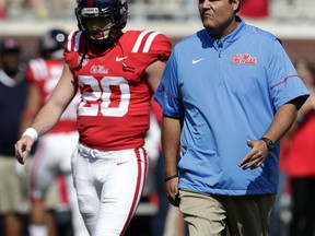 Mississippi quarterback Shea Patterson (20) walks with interim football coach Matt Luke during a pregame drills before an NCAA college football game against UT Martin in Oxford, Miss., Saturday, Sept. 9, 2017.(AP Photo/Rogelio V. Solis)