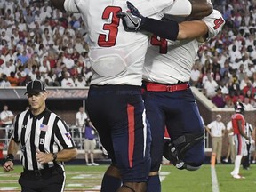 South Alabama wide receivers Jamarius Way (3) and Tre Nixon (4) celebrate Way's touchdown during the first half of an NCAA college football game against Mississippi in Oxford, Miss., Saturday, Sept. 2, 2017. (AP Photo/Thomas Graning)