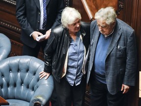 Uruguay's newly named Vice President Lucia Topolansky leaves Senate chambers with her husband former President Jose Mujica, after presiding over a session in her new role, in Montevideo, Uruguay, Wednesday, Sept. 13, 2017.  Vice President Raul Sendic resigned Wednesday amid allegations of corruption and was replaced by Topolansky, the first woman in Uruguay to hold that position. (AP Photo/Matilde Campodonico)