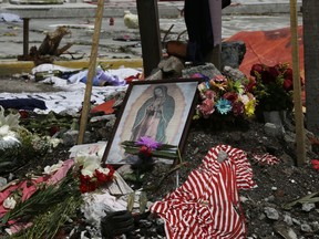 A photo of the Virgin of Guadalupe stands in a memorial at the site of a building that collapsed in last week's 7.1 magnitude earthquake, in the Obrera neighborhood of Mexico City, Wednesday, Sept. 27, 2017. Across Mexico City, some 40 buildings collapsed in the earthquake and hundreds of others were so severely damaged they will either have to be demolished or receive major structural reinforcement, according to Mexico City Mayor Miguel Angel Mancera. (AP Photo/Marco Ugarte)