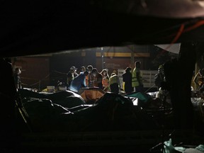 Volunteers organize supplies at the Francisco Kino school, which was turned into a temporary shelter for residents evacuated from the large apartment complex in the Tlalpan neighborhood of Mexico City, Monday, Sept. 25, 2017.  The 7.1 magnitude quake on Sept. 19 left the complex's 500 residents, mostly government employees, without a home after one of the 11 buildings collapsed and the others were damaged. (AP Photo/Natacha Pisarenko)