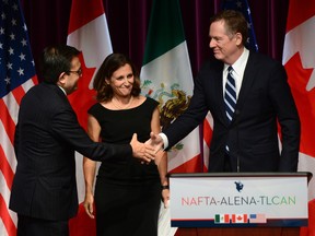 Mexico's Secretary of Economy Ildefonso Guajardo Villarreal (left) shakes hands with United States Trade Representative Robert Lighthizer as Canada's Foreign Affairs Minister Chrystia Freeland looks on at a news conference on the NAFTA negotiations in Ottawa.