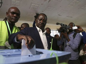 FILE - In this Tuesday, Aug. 8, 2017 file photo, Kenyan opposition leader Raila Odinga, center, casts his vote in the Kibera slum of Nairobi, Kenya. Kenya's electoral commission has announced Monday, Sept. 4, 2017 that fresh presidential elections will be held on Tuesday, Oct. 17, 2017, following the Supreme Court ruling that annulled the August elections. (AP Photo/Brian Inganga, File)