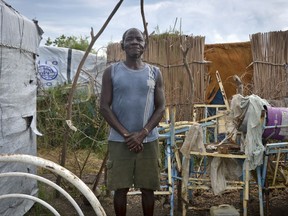 Ramadan Wani, who hasn't seen his family in the six years he has been stranded at a displaced persons' camp, stands outside his makeshift house in Payuer, South Sudan Monday, Aug. 21, 2017. South Sudan's independence from Sudan in 2011 drew thousands of people wanting to return to their hometowns in the world's newest nation, but civil war has stranded many of them for years in a border town, far from their families. (AP Photo/Sam Mednick)