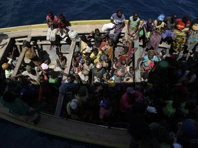 FILE - In this Saturday, May 23, 2015 file photo, refugees who fled Burundi's violence and political tension wait in a speedboat to board a ship freighted by the UN, at Kagunga on Lake Tanganyika, Tanzania. The international human rights organization Amnesty International said Friday, Sept. 29, 2017 that thousands of Burundi refugees are being pressured to go home where they risk being killed, tortured or raped. (AP Photo/Jerome Delay, File)