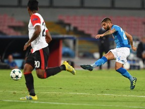 Napoli forward Lorenzo Insigne, right, scores a goal during the Uefa Champions League, Group F soccer match between Napoli and Feyenoord at the San Paolo stadium in Naples, Italy, Tuesday, Sept. 26, 2017. (Ciro Fusco/ANSA via AP)