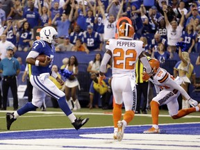 Indianapolis Colts quarterback Jacoby Brissett (7) runs in for a touchdown in front of Cleveland Browns free safety Jabrill Peppers (22) during the first half of an NFL football game in Indianapolis, Sunday, Sept. 24, 2017. (AP Photo/AJ Mast)
